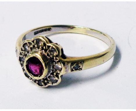 A hallmarked 375 gold flowerhead ring, set with tiny ruby and diamonds - boxed