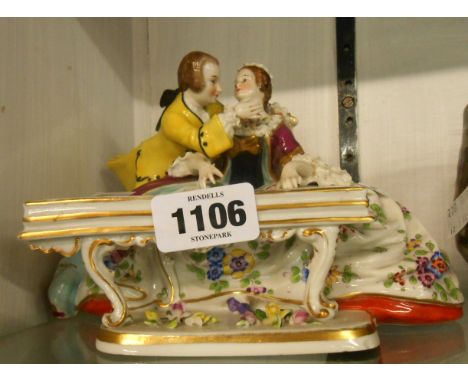 A 20th Century Sitzendorf figure group of a lady playing a harpsichord and a gentleman admirer