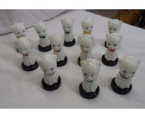 Twelve vintage glass and bakelite cat perfume bottles