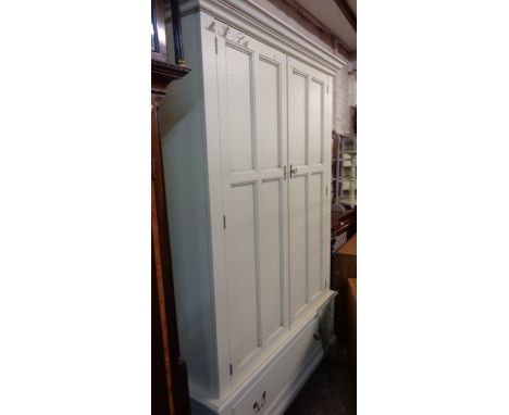 A 1.30m Laura Ashley painted wood double wardrobe with moulded cornice and hanging space enclosed by a pair of panelled doors