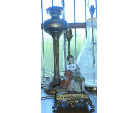 A brass table oil lamp and Italian Capodimonte figure lamp on gilt brass base