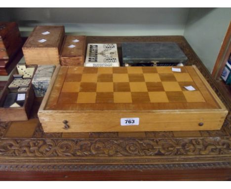 Two vintage wooden chess sets, dominoes, patience cards, draughts, a folding board and a carved wood chess board