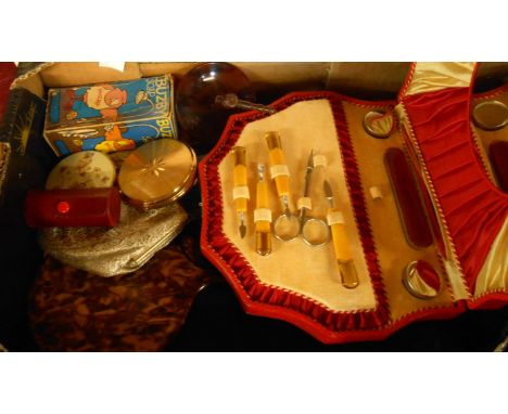 A box containing assorted vintage vanity items including compact, manicure set, etc.