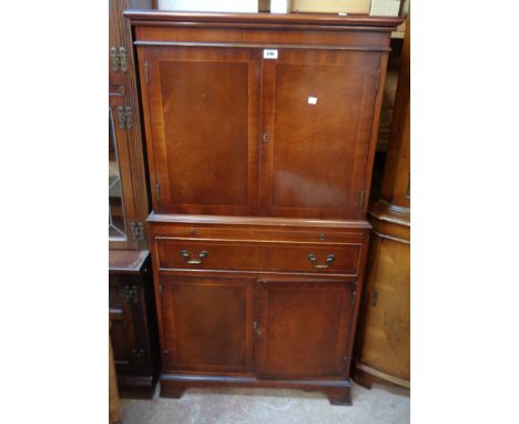 A 75cm reproduction mahogany and crossbanded drinks cabinet with two doors to top, slide, long drawer and two further cupboar