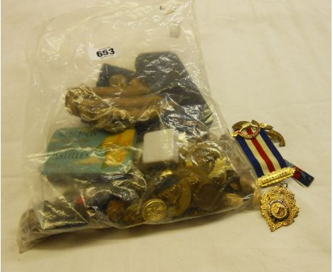 A collection of military cap badges including Cameronians (Scottish Rifles) on Douglas tartan patch, Army Pay Corps, Devonshi