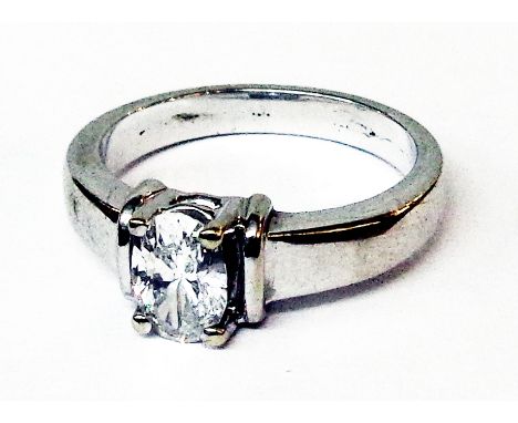 A marked 750 white metal oval cut diamond solitaire ring - approx .75ct. - size L