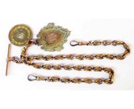 A marked 15ct ornate double Albert watch chain with T-bar and two lobster clasps, set with two 9ct. gold fobs