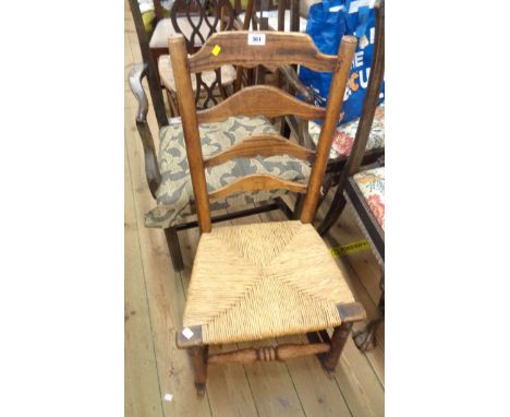 An antique elm ladder back rocking chair with woven rush seat - a/f