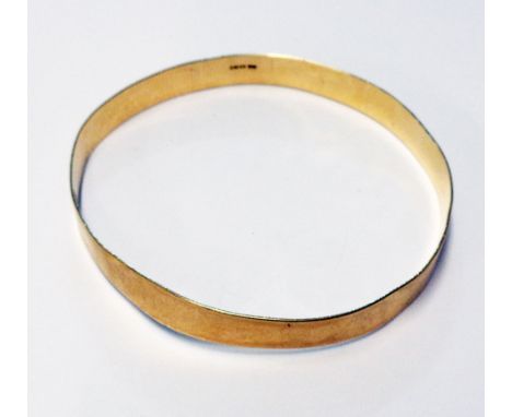 A hallmarked 9ct. gold bangle