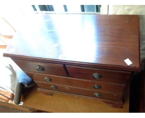 A 55cm reproduction small chest of two short and two long graduated drawers, set on bracket feet - wear