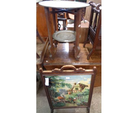 An old stained wood folding two tier table with brassed metal tray surfaces - sold with a woolwork panel firescreen - various