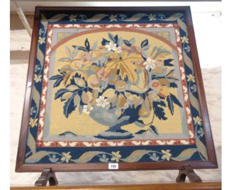 A 20th Century stained wood framed firescreen with large central woolwork panel