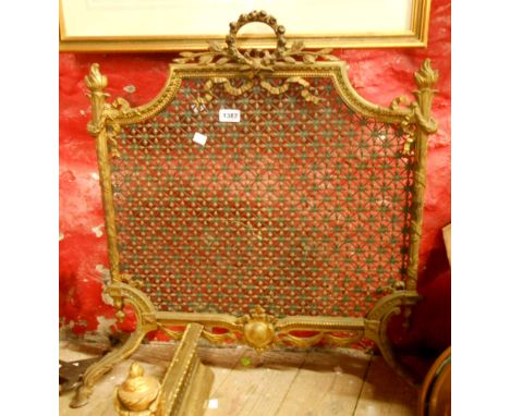 A late Victorian gilt brass firescreen decorated in the Rococo style with reticulated screen