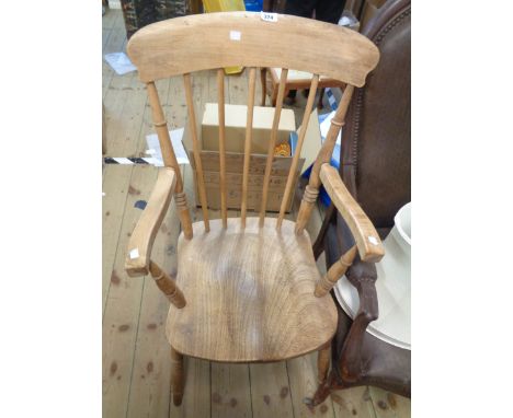 A 20th Century Windsor high stick back elbow chair with moulded solid elm seat, set on ring turned supports