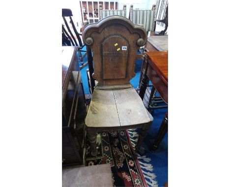 An oak ladder back chair and an oak hall chair
