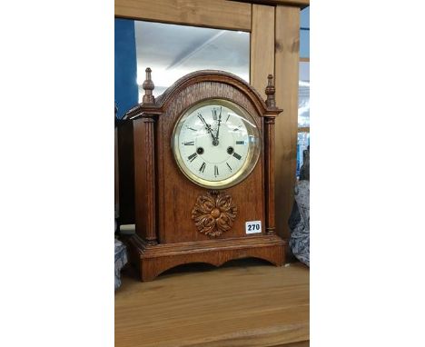 An oak cased mantle clock
