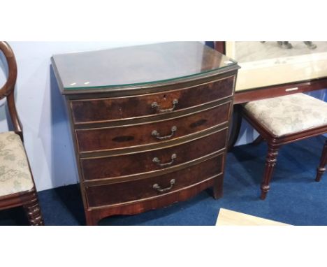 A walnut bow front chest of drawers