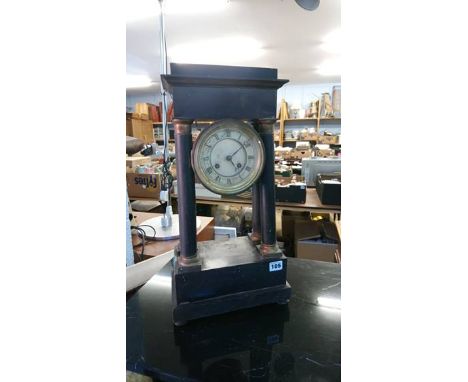 An ebonised mantle clock