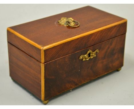 A GEORGIAN WALNUT TWO DIVISION TEA CADDY, with brass escutcheons, ball feet and ring handle, original inner lids all with mat