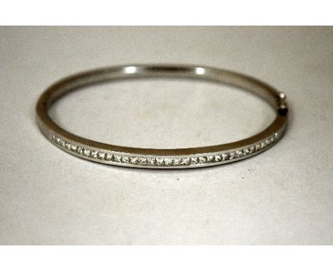 AN 18CT GOLD DIAMOND BANGLE, with square cut diamonds to one side, estimated total diamond weight 2cts, diameter 6cm, hallmar