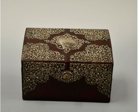 A SILVER MOUNTED SLOPED RECTANGULAR STATIONERY BOX, with embossed and pierced floral and scroll decoration, central cartouche