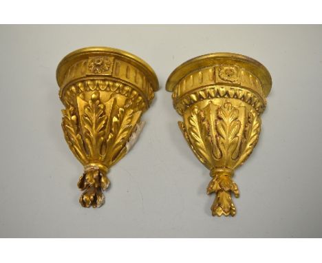 TWO GILT WOOD AND GESSO WALL SCONCES, with moulded floral mounts under shelf to ribbed band over fern leaves, approximately 2