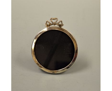 A CIRCULAR SILVER PICTURE FRAME, with bow to top and easel back, London 1902, approximately 10.5cm diameter