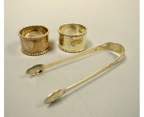 A PAIR OF SILVER NAPKIN RINGS, monogrammed K with beaded edges, Sheffield 1913, together with engraved swag and floral decora