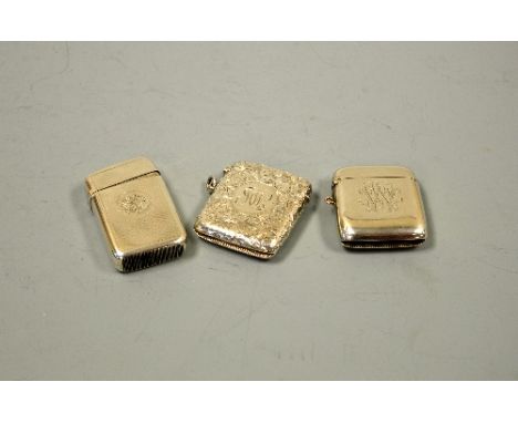 THREE SILVER VESTAS, all monogrammed, one with engraved scroll design, Birmingham 1900, one engine turned Birmingham 1872 and