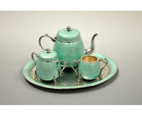 A FOUR PIECE ORIENTAL DUCK EGG BLUE ENAMELLED TEA SERVICE, of globular form comprising teapot, sugar bowl and milk jug on ova