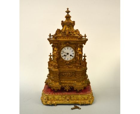 A LARGE EIGHT DAY GILT MANTEL CLOCK, with female figural mounts either side circular white enamelled dial with Roman numerals