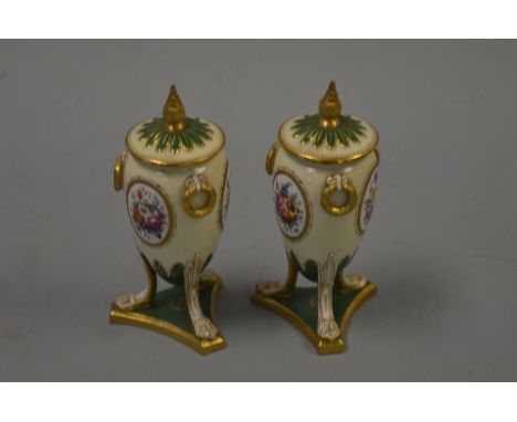 A PAIR OF SPODE LIDDED VASES, of elongated ovoid form on three legs with claw feet set on triangular base with hand painted f