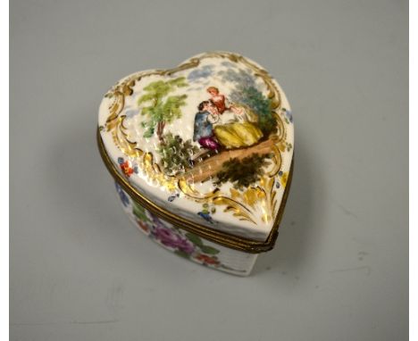 A CONTINENTAL CERAMIC HEART SHAPED BOX, decorated in coloured enamels with maiden and dandy in parkland to hinged lid and flo