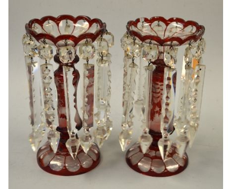 A PAIR OF RUBY GLASS BOHEMIAN LUSTRES, the body decorated with stag in forest, scalloped bowl over shaped body on circular fo