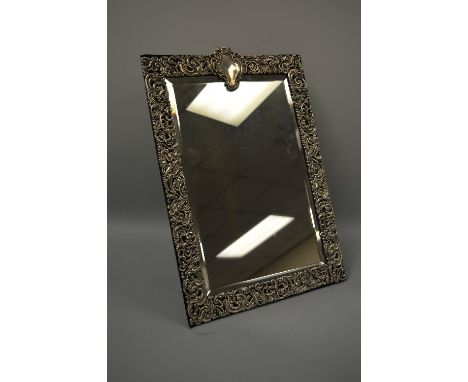 A SILVER RECTANGULAR EASEL MIRROR, with pierced scrollwork, vacant cartouche and bevelled glass, London 1902, approximately 5