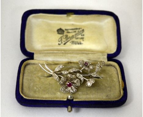 A DIAMOND AND RUBY BROOCH, designed as flowers and foliage with old-cut diamonds and central rubies, with fitted box