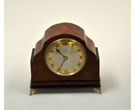 A WALNUT CASED DOME TOPPED BARREL CLOCK, with silvered dial inscribed Harrods Ltd London SW1 and gilt chapter ring with black