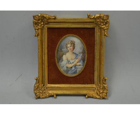 AN OVAL PORTRAIT MINIATURE, young woman in blue gown with dove, monogrammed JGH bottom right, set in gilt frame, approximatel