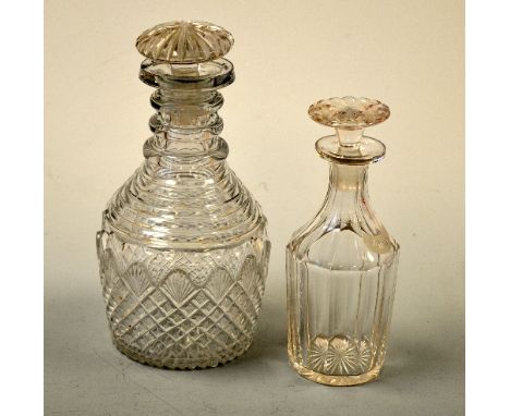 A TAPERING CUT GLASS DECANTER, with opaque RHUM label, approximately 19cm high, together with a neck slice cut decanter, appr