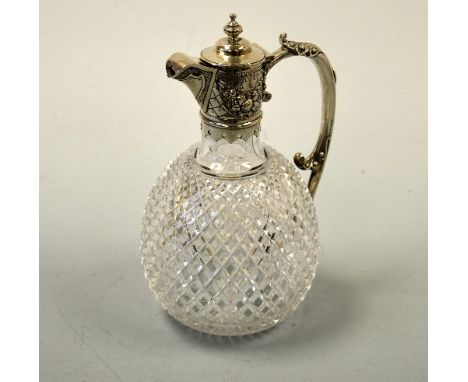 A GLOBULAR CUT GLASS VICTORIAN CLARET JUG, with silver mounted top and handle with embossed floral decoration and urn finial 