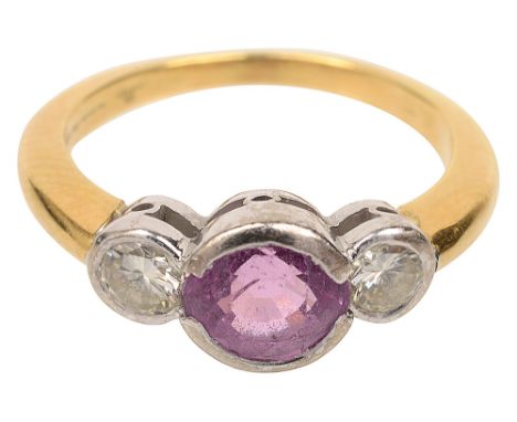 A pink sapphire and two stone diamond ringthe central mixed-cut pink sapphire set to either side with a brilliant-cut diamond