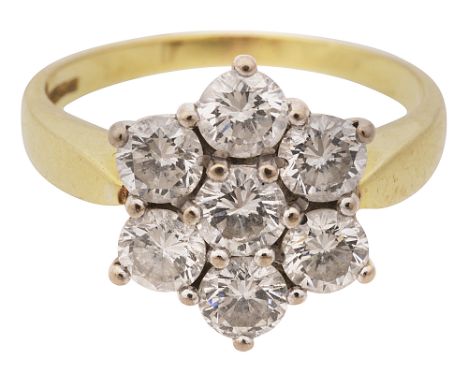 A diamond seven stone ring, the brilliant-cut diamonds set as a flowerhead cluster to the 18ct white gold basket mount and ye