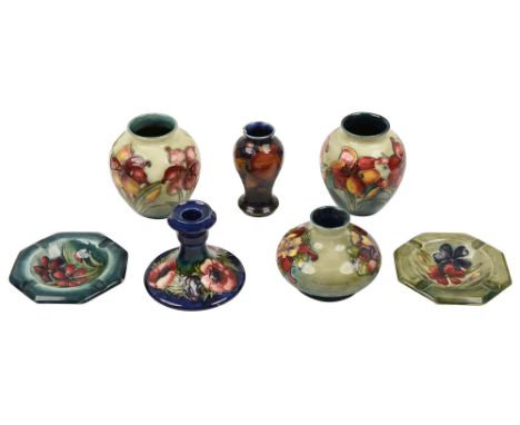 A collection of seven pieces of Moorcroftincluding: two 'African Lily' pattern vases, design slightly differing each decorate