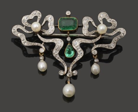 An Edwardian emerald, pearl and diamond-set broochthe elaborate openwork bow and ribbon design set to the centre with a recta