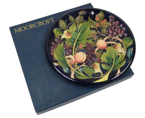 A Moorcroft 'Queens Choice' pattern charger,designed by Emma Bossons, 2000, tube line decorated against dark blue ground, imp