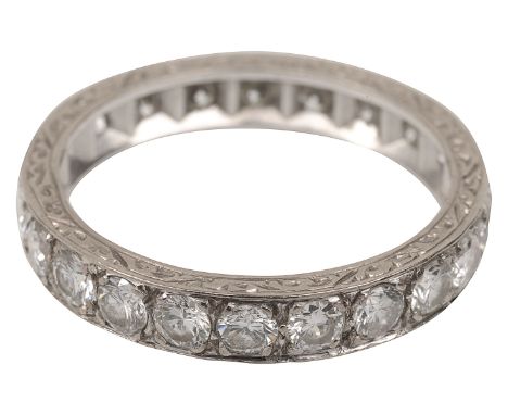 A full hoop diamond-set eternity ring, set all round with brilliant-cut diamonds, the engraved sides stamped '18CT'ring size 