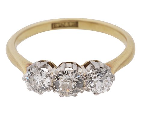 A diamond three stone ring, set with three brilliant-cut diamonds coronet-set to the plain tapering shank stamped '18ct&PLAT'