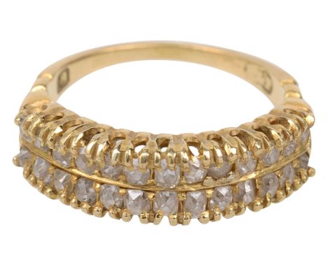 A two row diamond-set ring, the top section set with two rows of slightly graduated cushion-shaped old-cut diamonds, to the b