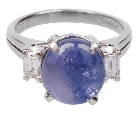 A star sapphire and diamond-set ringthe oval cabochon star sapphire claw-set to either side with a baguette-cut diamond, the 