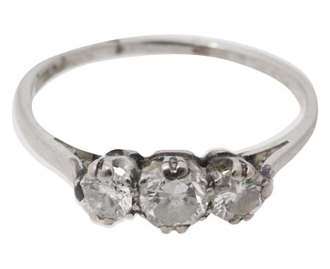 A three stone diamond ring,the graduated brilliant-cut diamonds coronet-set to the plain hoop stamped 'PLAT'ring size N, 2.4g